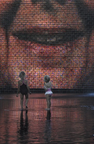 Two girls standing in front of the Crown Fountain