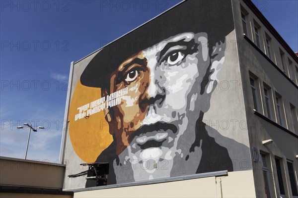 Portrait of the artist Joseph Beuys on a house wall