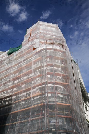 Building with scaffolding undergoing exterior renovations