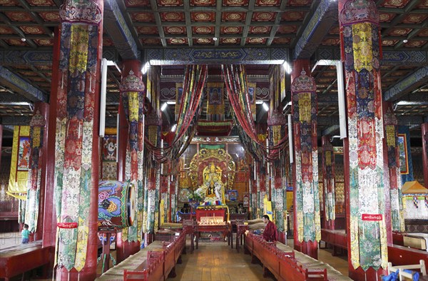 Monk praying in the prayer hall in Amarbayasgalant Monastery
