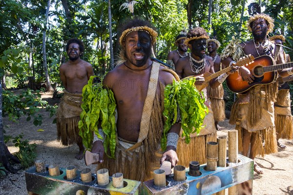 Group of traditional dressed men playing music