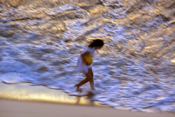Woman on the beach in the evening