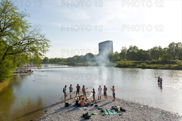 Young people having party on the Isar River in summer