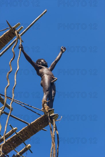 Man jumping from a bamboo tower