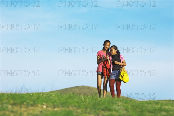 Girls with their mobile phones in the hills of Khakhorin