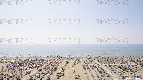 View of a beach with sunshades and sun beds in the morning