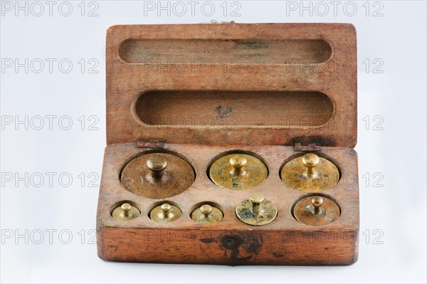 Old brass weights in wooden box with lid