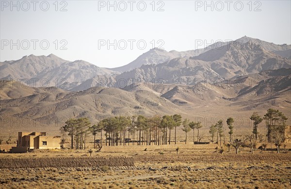 Isolated house and trees in the Kuhrud Mountains