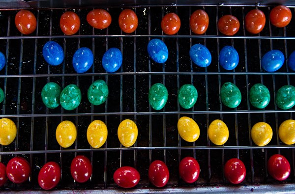 Brightly coloured Easter eggs on a conveyor belt