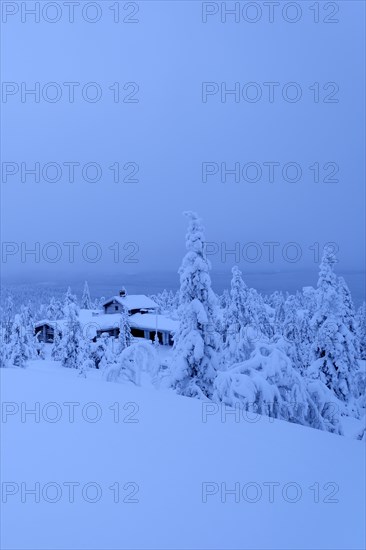 Finnish log cabin in the snow-covered landscape
