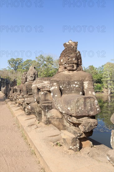Asura statues aligned at the south gate causeway of Angkor Thom