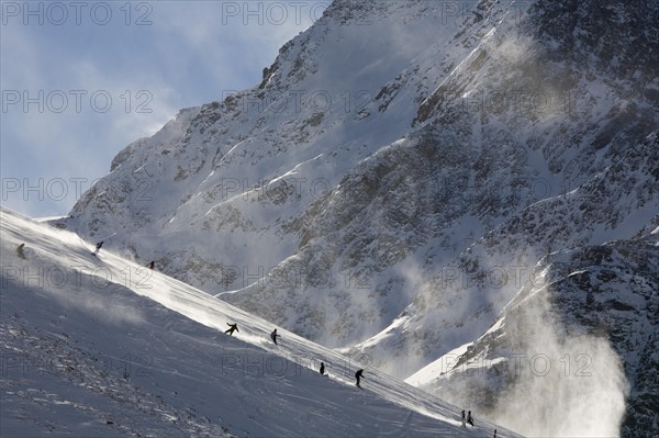 Skiers going downhill