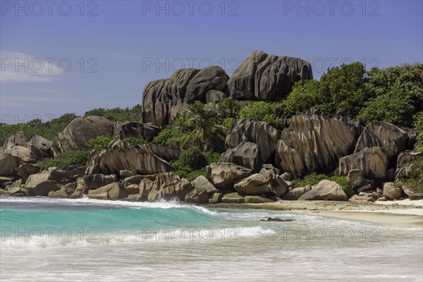 Sandy beach with the rock formations typical for the Seychelles