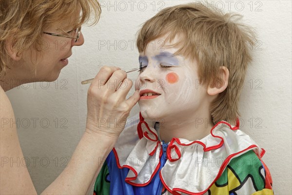 Little boy dressed as a clown