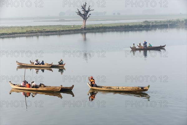 Fishermen in their boats in the morning light