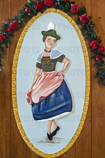 Woman dancing the Schuhplattler in Bavarian dress