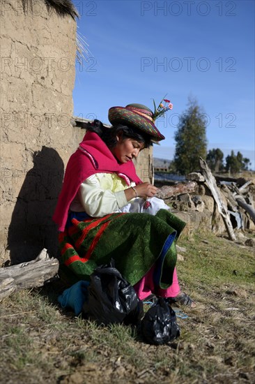 Young woman embroidering a cloth with traditional patterns