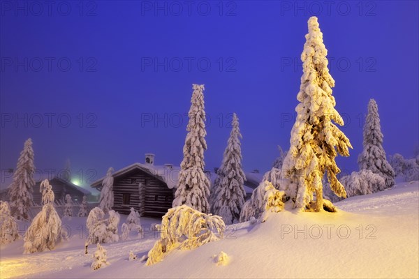 Finnish log cabin in the snow-covered landscape