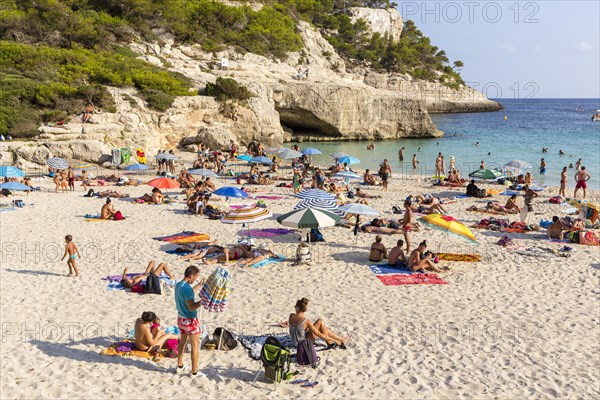 Tourists on the sandy Cala Mitjana Beach