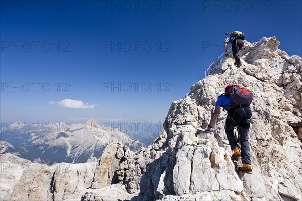 Mountain climbers climbing on the Via Ferrata Marino Bianchi climbing route on Monte Cristallo