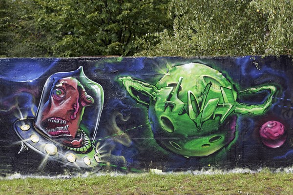 Alien shooting towards a green planet