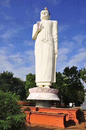 Giant Buddha statue in front of a monastery