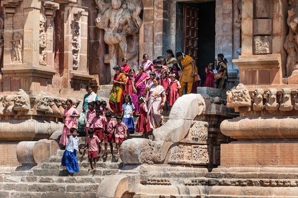 Children and devout Hindus descending a staircase