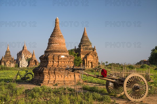 Cart and a bicycle in front of pagoda
