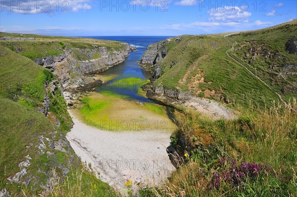 Sea inlet with a trail to a viewpoint at Smoo Cave