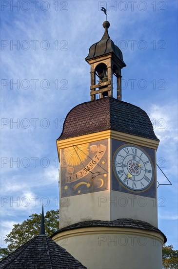 Sundial and a mechanical clock in the clock tower with a time shift in the summertime