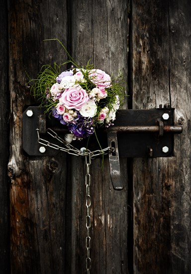 Bridal bouquet in an old door lock