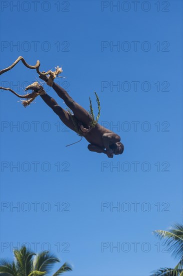 Man jumping from a bamboo tower