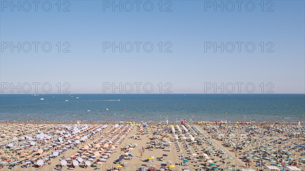 View of a beach with sunshades and sun beds in the afternoon