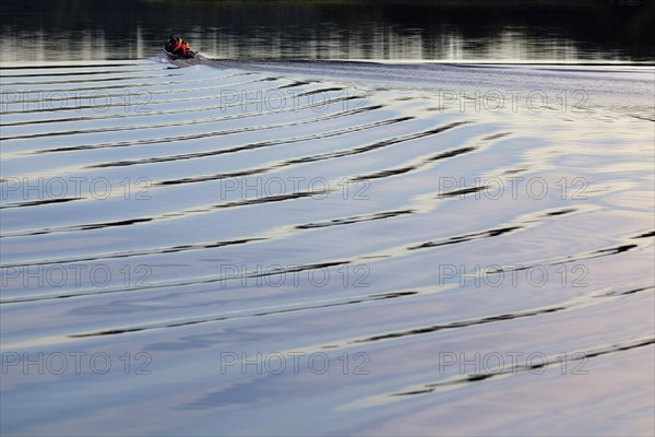 Boat with stern waves on Lake Asnen