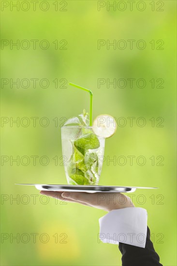 Hugo cocktail with lime and mint being served on a tray