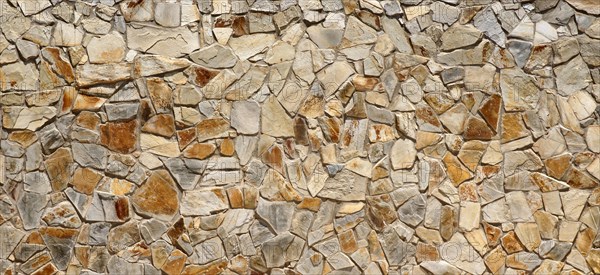 Wall of many beige natural stones