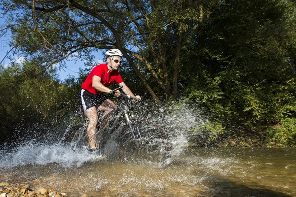 Mountain biker crossing a stream