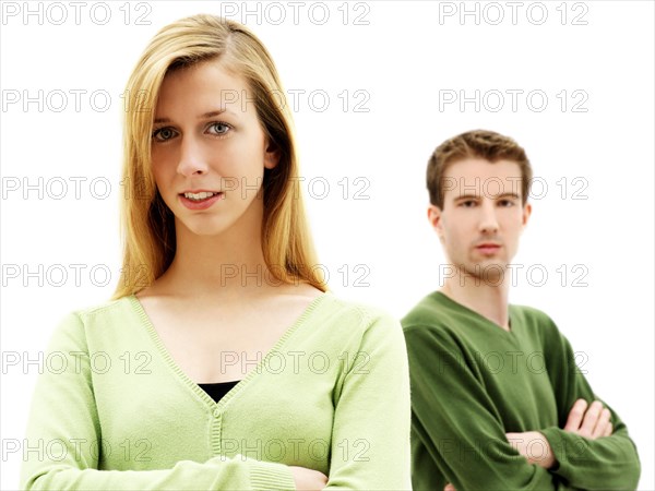 Young couple standing with their arms crossed