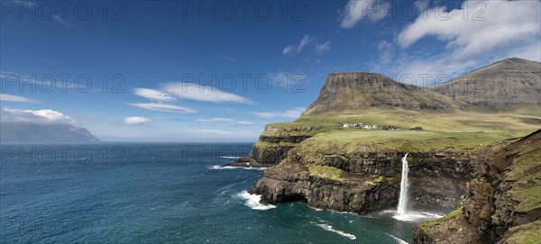 Cliffs with a waterfall near a village