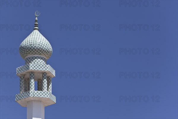 Crescent moon and a star at the top of a minaret