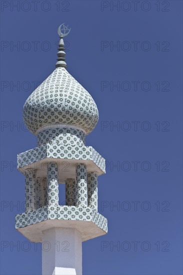Crescent moon and a star at the top of a minaret