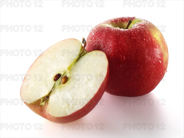 One whole and one cut Red Discovery apple