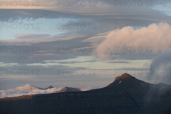 Mountain landscape in the evening light with a cloudy sky