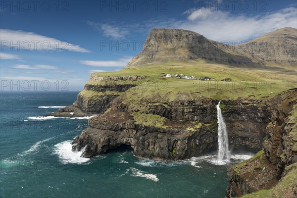 Waterfall on the cliffs near a village