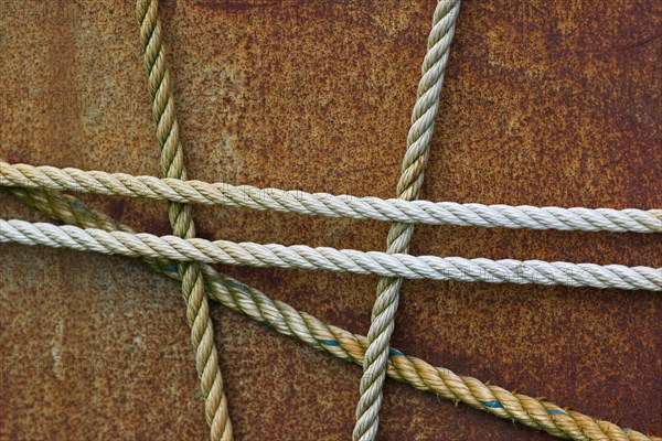 Taut ropes on a rusty surface