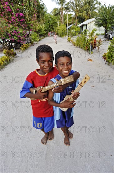 Two boys with ukulele toys