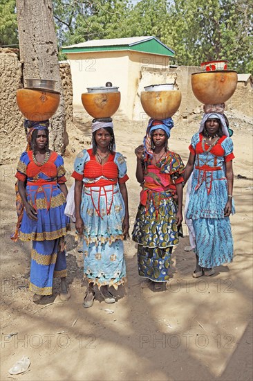Fulani women carrying milk calabashes on their heads