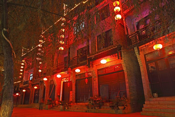 Red illuminated row of houses at night