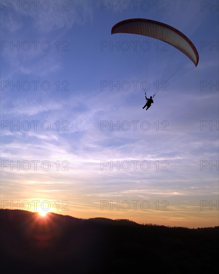 Paraglider at sunset
