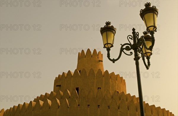 A tower of the Al Ain Palace Museum or Sheikh Zayed Palace Museum and a street lamp